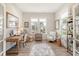 Bright home office with wooden desk, ample natural light, and stylish decor at 2383 Lenwick Hall Ln, Johns Island, SC 29455