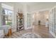 Home office view into the entry and stairs, with ample light and neutral tones at 2383 Lenwick Hall Ln, Johns Island, SC 29455
