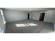 Large main bedroom featuring neutral carpet, a window, and two doors at 262 Wild Strawberry Ln, Moncks Corner, SC 29461