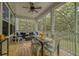 The screened porch has views of the natural setting, a dining table and an outdoor seating area at 2856 Claybrook St, Johns Island, SC 29455