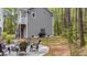 Exterior view showcasing backyard with a paver patio with fire pit and wooded surroundings at 2856 Claybrook St, Johns Island, SC 29455