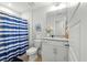 Clean bathroom with a modern vanity, toilet, and shower with a blue striped curtain at 2856 Claybrook St, Johns Island, SC 29455