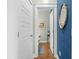 Hallway view of a half bath featuring designer doors and blue accent wall and luxury finishes at 2856 Claybrook St, Johns Island, SC 29455