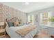 Charming bedroom featuring floral wallpaper, soft natural light, and a quaint writing desk at 2856 Claybrook St, Johns Island, SC 29455