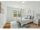 Serene bedroom with a four poster bed, a view of the outside and coastal-themed decor at 2856 Claybrook St, Johns Island, SC 29455