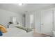 Serene bedroom with white walls, plush bedding, and an open doorway to an en-suite bathroom at 2856 Claybrook St, Johns Island, SC 29455
