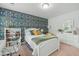 Bright bedroom featuring a white bed frame, floral wallpaper, and ample natural light from a window at 2856 Claybrook St, Johns Island, SC 29455