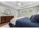 Bright bedroom with a tray ceiling, fan, and a dresser with a decorative mirror and lamps at 2856 Claybrook St, Johns Island, SC 29455