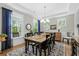 Inviting dining room featuring a farmhouse table, natural light, tray ceilings, and wood floors at 2856 Claybrook St, Johns Island, SC 29455