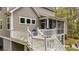 Exterior view of the home, deck with grill, and screened-in porch at 2856 Claybrook St, Johns Island, SC 29455