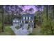 Charming two-story home with a double garage and welcoming front porch nestled among tall trees at 2856 Claybrook St, Johns Island, SC 29455