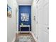 Hallway with stylish decor, featuring a vibrant blue accent wall and elegant console table at 2856 Claybrook St, Johns Island, SC 29455