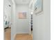 Well-lit hallway leading to a bedroom and bathroom, adorned with beach-themed artwork at 2856 Claybrook St, Johns Island, SC 29455