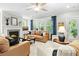 Bright living room features a fireplace, ceiling fan, and large windows with views of the outdoors at 2856 Claybrook St, Johns Island, SC 29455