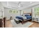 Spacious main bedroom featuring a tray ceiling, hardwood floors, and bright, airy windows at 2856 Claybrook St, Johns Island, SC 29455