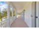 Covered porch area with white columns provides shade to outdoor space at 301 Hidden Bottom Ln, Daniel Island, SC 29492