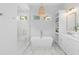 Modern bathroom with a soaking tub, glass enclosed shower, and marble floors at 301 Hidden Bottom Ln, Daniel Island, SC 29492