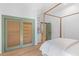 A bright bedroom offers paneled doors, a light wood frame bed, and closet with lattice doors at 301 Hidden Bottom Ln, Daniel Island, SC 29492