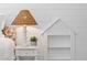 A white nightstand with lamp and plant is next to a small bookcase built into the bright bedroom wall at 301 Hidden Bottom Ln, Daniel Island, SC 29492