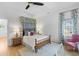 Charming bedroom features a queen bed, wood floors, and natural light at 301 Hidden Bottom Ln, Daniel Island, SC 29492