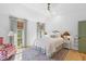 Bright bedroom features white walls, a floral headboard, and an area rug creating a cozy, inviting atmosphere at 301 Hidden Bottom Ln, Daniel Island, SC 29492