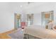 A bright bedroom offers an oversized rug, white walls and ceilings, and three windows creating an airy space at 301 Hidden Bottom Ln, Daniel Island, SC 29492