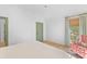 The bedroom boasts green paneled doors and trim, accenting the white walls and bright, natural lighting at 301 Hidden Bottom Ln, Daniel Island, SC 29492