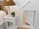 A detailed view showcases a white nightstand and adjacent bookcase in a bedroom with white, shiplap walls at 301 Hidden Bottom Ln, Daniel Island, SC 29492