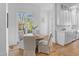 Bright breakfast nook with large windows and a view to the yard, adjacent to the kitchen at 301 Hidden Bottom Ln, Daniel Island, SC 29492