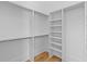 Spacious walk-in closet with custom shelving and ample hanging space and hardwood floors at 301 Hidden Bottom Ln, Daniel Island, SC 29492
