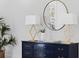 Close-up on the stylish console table with lamps and decorative mirror, enhancing the room's ambiance at 301 Hidden Bottom Ln, Daniel Island, SC 29492