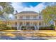 Stunning two-story home showcasing a grand columned porch and manicured front yard at 301 Hidden Bottom Ln, Daniel Island, SC 29492