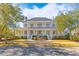 Beautiful two-story home with a welcoming front porch and landscaped yard, creating a charming facade at 301 Hidden Bottom Ln, Daniel Island, SC 29492