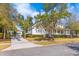 Charming two-story home with a detached garage and lush landscaping offering curb appeal at 301 Hidden Bottom Ln, Daniel Island, SC 29492
