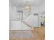 Bright foyer showcasing hardwood floors, a staircase, and an open floor plan at 301 Hidden Bottom Ln, Daniel Island, SC 29492