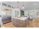 Open-concept kitchen with stainless steel appliances, a center island, and plenty of storage at 301 Hidden Bottom Ln, Daniel Island, SC 29492