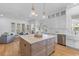 Bright kitchen boasts a large center island, stainless steel appliances, and seamless flow to the living area at 301 Hidden Bottom Ln, Daniel Island, SC 29492