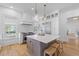 Well-appointed kitchen showcases stainless steel appliances, a center island, and views from the large windows at 301 Hidden Bottom Ln, Daniel Island, SC 29492