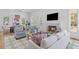 Bright living room showcasing a fireplace, comfortable seating, and open layout to the dining area at 301 Hidden Bottom Ln, Daniel Island, SC 29492