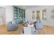 Comfortable seating arrangement in the living room with custom built-ins and access to outdoor living spaces at 301 Hidden Bottom Ln, Daniel Island, SC 29492
