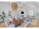 Open-concept living and dining areas with hardwood floors and stylish furnishings at 301 Hidden Bottom Ln, Daniel Island, SC 29492