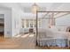 Sun-filled main bedroom featuring a sitting area and large four poster bed at 301 Hidden Bottom Ln, Daniel Island, SC 29492