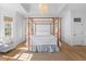 Bright main bedroom boasts a four poster bed, wood floors and lots of natural light at 301 Hidden Bottom Ln, Daniel Island, SC 29492