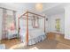 Large main bedroom with a four poster bed, area rug, and hardwood floors at 301 Hidden Bottom Ln, Daniel Island, SC 29492
