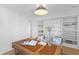Bright home office featuring built-in bookshelves, a wicker desk, and comfortable seating at 301 Hidden Bottom Ln, Daniel Island, SC 29492