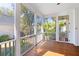 Inviting screened porch with wood floors and views of the lush backyard at 301 Hidden Bottom Ln, Daniel Island, SC 29492