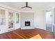 Bright sunroom with hardwood floors, painted brick fireplace, and neutral paint colors at 301 Hidden Bottom Ln, Daniel Island, SC 29492