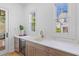 Stylish wet bar features custom cabinetry, a wine cooler, and a marble countertop at 301 Hidden Bottom Ln, Daniel Island, SC 29492