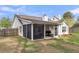 Exterior home view showcases spacious screened-in porch and level backyard with privacy fence at 311 Old Stone Ct, Moncks Corner, SC 29461