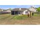 Spacious backyard features a screened-in porch, grassy lawn, and playful swing set at 311 Old Stone Ct, Moncks Corner, SC 29461